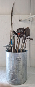 (1) Metal Trash Can W/ (1) Round Nosed Shovel, (1) Square Nosed Shovel, (1) Garden Hoe, (1) Hard Rake, (1) Limb Saw & More