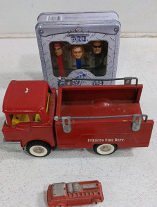 (1) Structo Fire Department Metal Truck (1) Toy Plastic/Rubber on Wheels Firetruck (1) Orange County Chopper Pez Dispenser