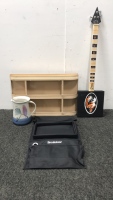 Handmade water pitcher, handmade 3 string guitar, a metal wall shelf and armrest organizer