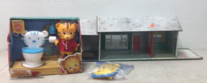 (1) Vintage Metal Play Doll House (1) Daniel Tigers Neighbor Hood Potty Time Toy (1) ThinkinFun Raping Rapids Toy