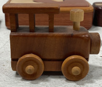 (1) Lot of Various Wooden Trinkets and Home Decor Such as; (1) Small Wooden Train (1) Wooden Puzzle Box (1) Porcelain White Dog (2) Small Wooden Containers, and more! - 5