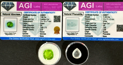 (2) AGI Certified Natural Gemstones w/ CoA&rsquo;s: (1) 7.85 Carat Cushion Cut Green Indocrase (1) 11.20 Carat White Phenakite