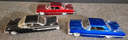 (1) JADA 1960 CHEVY IMPALA 1:24 DIECAST MODEL CAR, BLACK, (1) JADA 1963 CHEVY IMPALA 1:24 DIECAST MODEL CAR, BLUE & (1) JADA 1963 CHEVY IMPALA 1:24 DIECAST MODEL CAR, RED