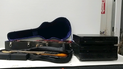 (1)Electric Guitar(Fender), (1)Acoustic Guitar(Stella), (1) Small INSIGNIA Speaker, (1) Onkyo Receiver, (1) Sony 5 CD Changer