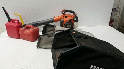 (1) Husqvarna Blower, (2) Gas Cans, (2) Lawnmower Bags