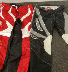 2 PAIRS OF MOTOCROSS PANTS (RED PAIR IS SIZE 40 ADULT, GREY PAIR IS SIZE 36).