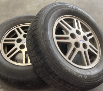 (2) BUICK RIMS (WITH DIFFERENT TIRES MOUNTED)