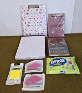 (2) Clipboards, 1-Big, 1-Small, (6) Pads Of White College Ruled Paper, (1) Check Register, (1) Pocket, Cell Phone Stand, (2) 3-Packs Of Letter Openers & (1) 6-Oz Bag Of Nerds Gummy Clusters