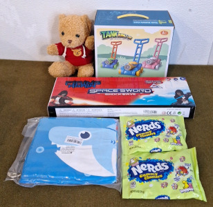 (1) 3-Pack Of Space Swords, (1) Tank Bubble Cart, (1) Teddy Bear & (2) 6-Oz Bags Of Nerds Gummy Clusters & (1) 32" x 63" Beach Towel