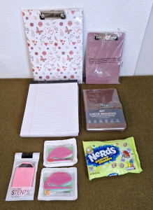 (2) Clipboards, 1-Big, 1-Small, (6) Pads Of White College Ruled Paper, (1) Check Register, (1) Pocket, Cell Phone Stand, (2) 3-Packs Of Letter Openers & (1) 6-Oz Bag Of Nerds Gummy Clusters