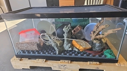 (1) 50 Gallon Reptile Tank (3) Heat Lamps (7) Bits of Decor (1) Thing of Tubing (1) Fish Net (1) Electric Flow Control System (1) Foam Pad For The Base