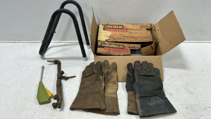 (1) Box of Lincoln welding rods (1) Welding tool & gloves (1) Motercycle Wheel chalk