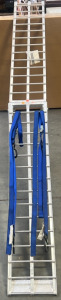 FOLDING ALUMINUM TRAILER RAMP WITH 2 BLUE STRAPS.