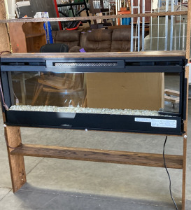 LARGE BOOK SHELF WITH BUILT IN FIREPLACE.