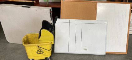 1/2 WHITEBOARD 1/2 PEG BOARD, (48” x 36”), SMALL WHITEBOARD ( 24”X 36”), FOLDING TABLE, YELLOW MOP BUCKET.