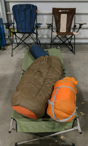 (1) Camping Essentials Bundle &ndash; (2) Ozark Trail Chairs, (1) Cot, (1) Slumberjack & (1) Marmot Sleeping Bag