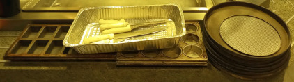 An Assortment of Kitchen Knifes and Baking Trays