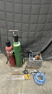 Oxygen Tank And Acetylene Tank On Roller Cart, (2) Hand Saws, (3) Caulk Guns, Various Extension Cables, Trailer Hitch, Hammer, Clamps, And More