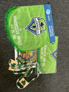 (2) Small Seattle Sounders FC vs. Manchester United Banners, St. Patrick's Costume Necklace, And Wall Art