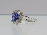 Platinum Natural Tanzanite Zoisite And Diamond Ring (size 6.5) Cushion Brilliant Cut Natural Tanzanite Zoisite Gemstone (1.87ct) Round Brilliant Cut Diamonds Accent Center Stone (0.70ct) Retail Value $11,570.00 - 3