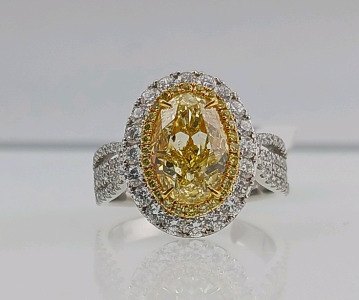 18K Yellow and White Gold Diamond Ring (size 6.5) Oval Modified Brilliant Cut Yellow Diamond (3.05ct) 130 Round Brilliant Cut Diamonds (1.23ct) Retail Value $44,750.00