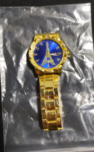 (1) Soki Stainless Steel Watch That's Gold Plated w/ (12) Diamond Studs & An Eiffel Tower Design