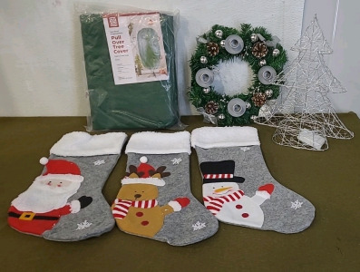 (1) Pull Over Christmas Tree Cover, (1) Advent Wreath/ Candle Holder, (1) Wire Tree Table Light, (1) 3-Piece Christmas Stocking Set & (1) Box Of Assorted Christmas Decor