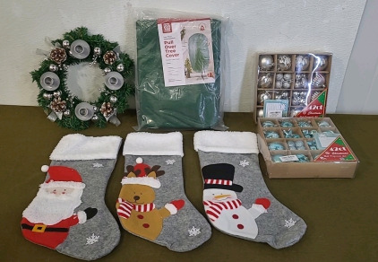 (1) Pull Over Christmas Tree Cover, (1) Advent Wreath/ Candle Holder, (2) Packages Of Christmas Tree Decorations, (1) 3-Piece Christmas Stocking Set & (1) Box Of Assorted Christmas Decor