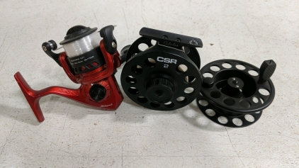 (2) Fishing Reels - (1) Shakespeare Red Spinning Reel (1) Cabela's CSR 2 Fly Reel