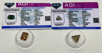 (2) Natural Gemstones W/ C.O.A.s (1) 5.95 Triangular Cut And Faceted Brown Enstatite And (1) 8.05ct. Color Changing Octagon Cut And Faceted Diaspore