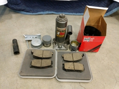(8) Automotive Tools and Parts - (1) 4-Ton Bottle Jack (4) Brake Pads (1) Nissan Cap