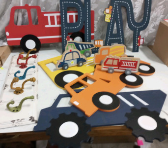 (1) White 5 Hook Coat Hanger (1) Blue Dump Truck Wall Decor (1) Orange Cement Truck Wall Decor (1) Red Fire Truck Wall Decor (1) Play Wall Decor With Road Design (1) Yellow Excavator Wall Decor And More Care Table Decor