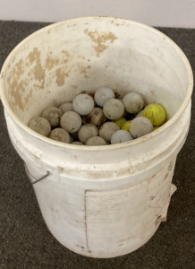 5 GALLON BUCKET WITH A LOT OF GOLF BALLS.