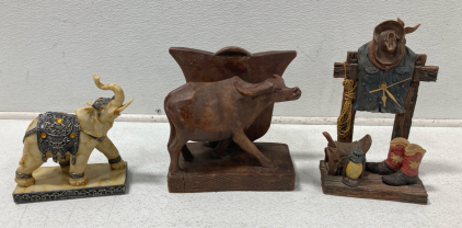 (1) Elephant Statue, (1) Vintage Wood Ox Statue, (1) Vintage 12” Cowboy Clock