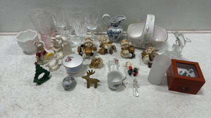 Various Christmas Decor Including Moving Music Box, Statues: Snowmen, Angels, Deer and More, Assortment of Kitchenware Including Cups, Teacups, Candlesticks, Pitchers, and More