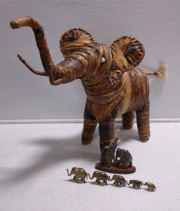 Giant Weaved Banana Leaf Elephant (1) Pair Of 6 Standing Marble Elephants On Wooden Display, & (1) Row of 5 Brass Elephants; Tallest 2" Going Down to Shortest 1"