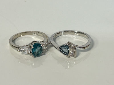 (2) .925 Rings: Size 8 Blue/ White Oval Aquamarine Ring and Size 10 Faceted Aquamarine Trillion Cut Ring