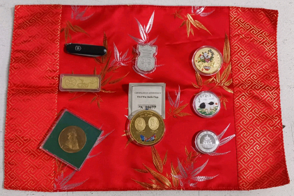 (7) Commemorative Coins (1) Decorative Red Placemat (1) Mini Swiss Army Knife