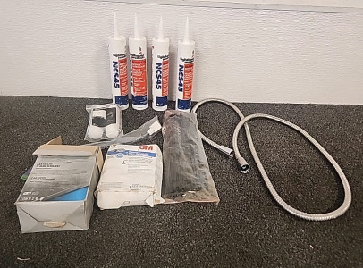 Home Improvement Supplies.. 4 Tubes of Acrylic Silicone.. a Bag of Tip Ties.. Respirator Filters.. Shower Hose..