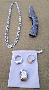 (3) Mens Rings, Size 10, (1) Chain Necklace & (1) Folding Lockblade Pocket Knife W/ Chain Pattern Handle