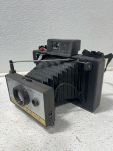 (1) Polaroid Automatic 215 Land Camera With Case And Light Attachment, Lightbulb, Batteries, And Samsonite Tackle Box With Lock