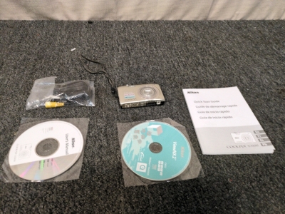 Nikon Camera with Instructional CDs, Cables, and Owners Manual