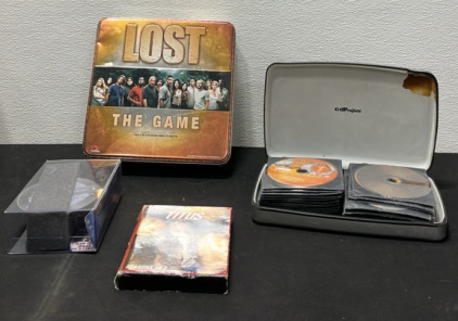 (2) Containers of DVD’s (1) Titus DVD Collection - Seasons 1 & 2 (1) Lost Game