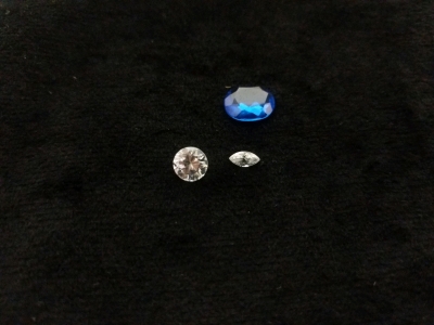 3) Jewelry Cut Stones, (1) White Marquis Cut, (1) White Round, (1) Blue Oval Cut