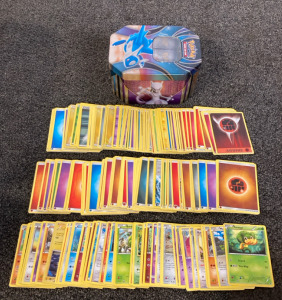 Assorted Pok&eacute;mon Cards & Collectible Tin