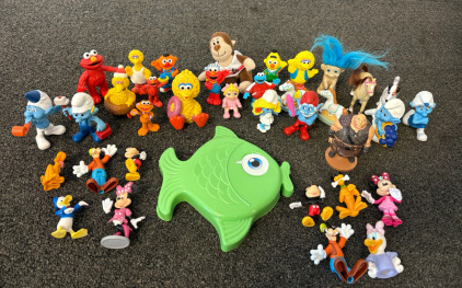 An Assortment of Figurines - Smurfs, Mickey Mouse, & More