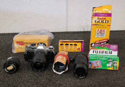 Cannon AE-1 Camera With Attachments And A Box Of Different Film.