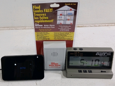 (3) Clocks & Home Alert Devices - (1) The Watchdog Water Alarm (1) Amazon Echo Show - Powers On (1) Accusplit Eagle 520S Timer Clock