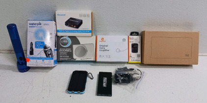 (10) Mixed Electronics Lot - (1) Waterpik Water Flosser (1) Blue Flashlight (1) Prozor Audio Converter (1) iChime Doorbell (1) Zoweetek Voice Amplifier (1) Scosche Bluetooth FM Transmitter (1) Cisco Device in Box (1) Solar Power Bank (1) Marvel Power Bank