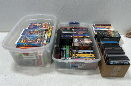 (69) Assortment of Various VHS Tapes Including Disney, Terminator, Spy Kids, and Much More, (23) Variety of DVD Movies Including Die Hard, Doom, Mr. & Mrs. Smith and More